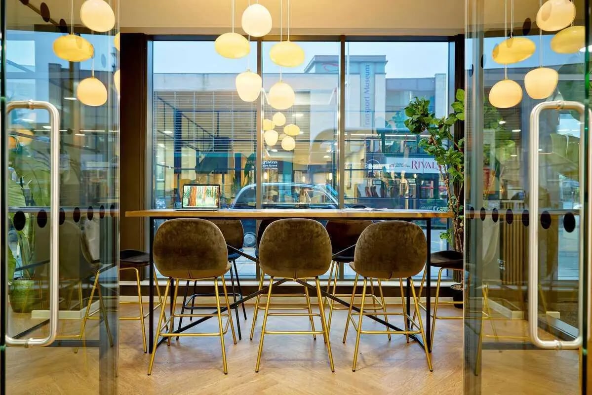 Bar stools laptop at table window area communal space at Millennium View in Coventry Student Accommodation
