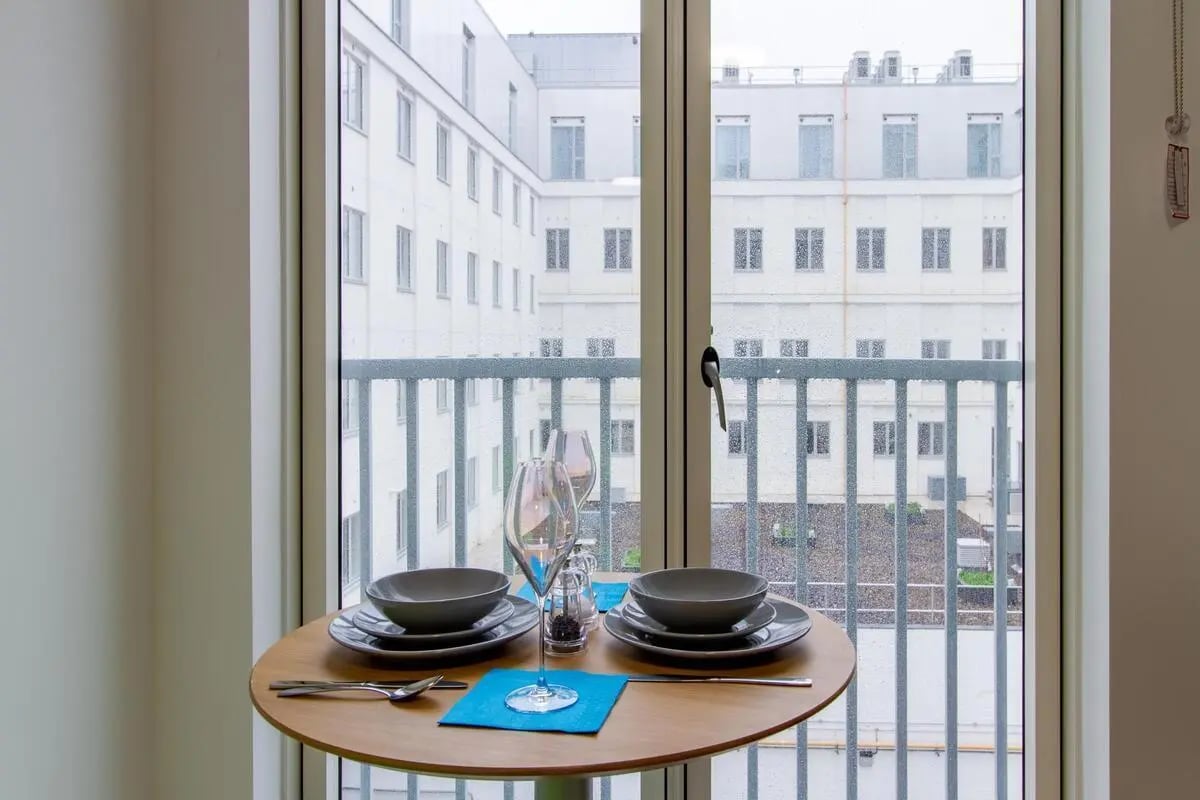 Table with plates glasses and cutlery exterior at Plymouth Cross House in Plymouth Student Accommodation