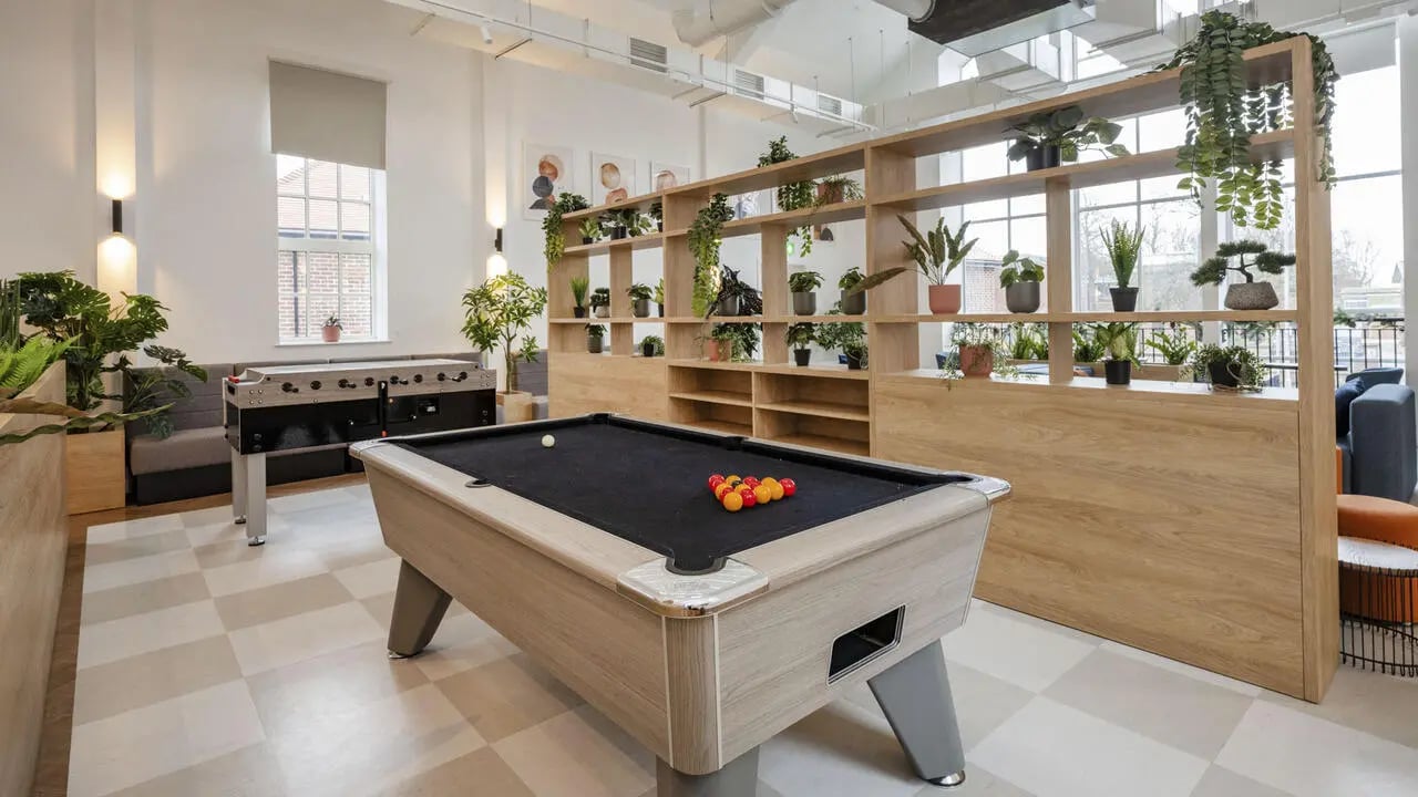 Pool table foosball table plants communal area at St Gabriels in Manchester Student Accommodation