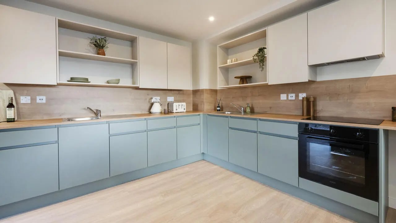 Light blue cabinets sink oven toaster kitchen at City Wharf in Glasgow Student Accommodation