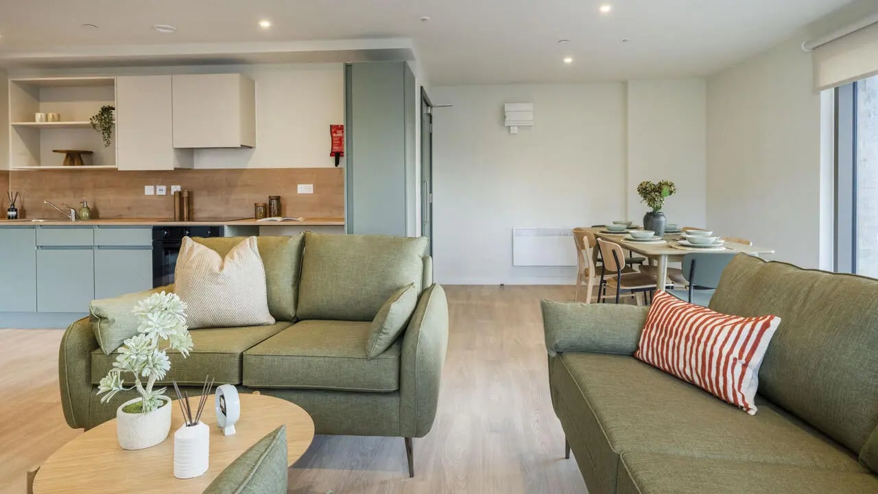 Sofas coffee table kitchen dining table living room at City Wharf in Glasgow Student Accommodation