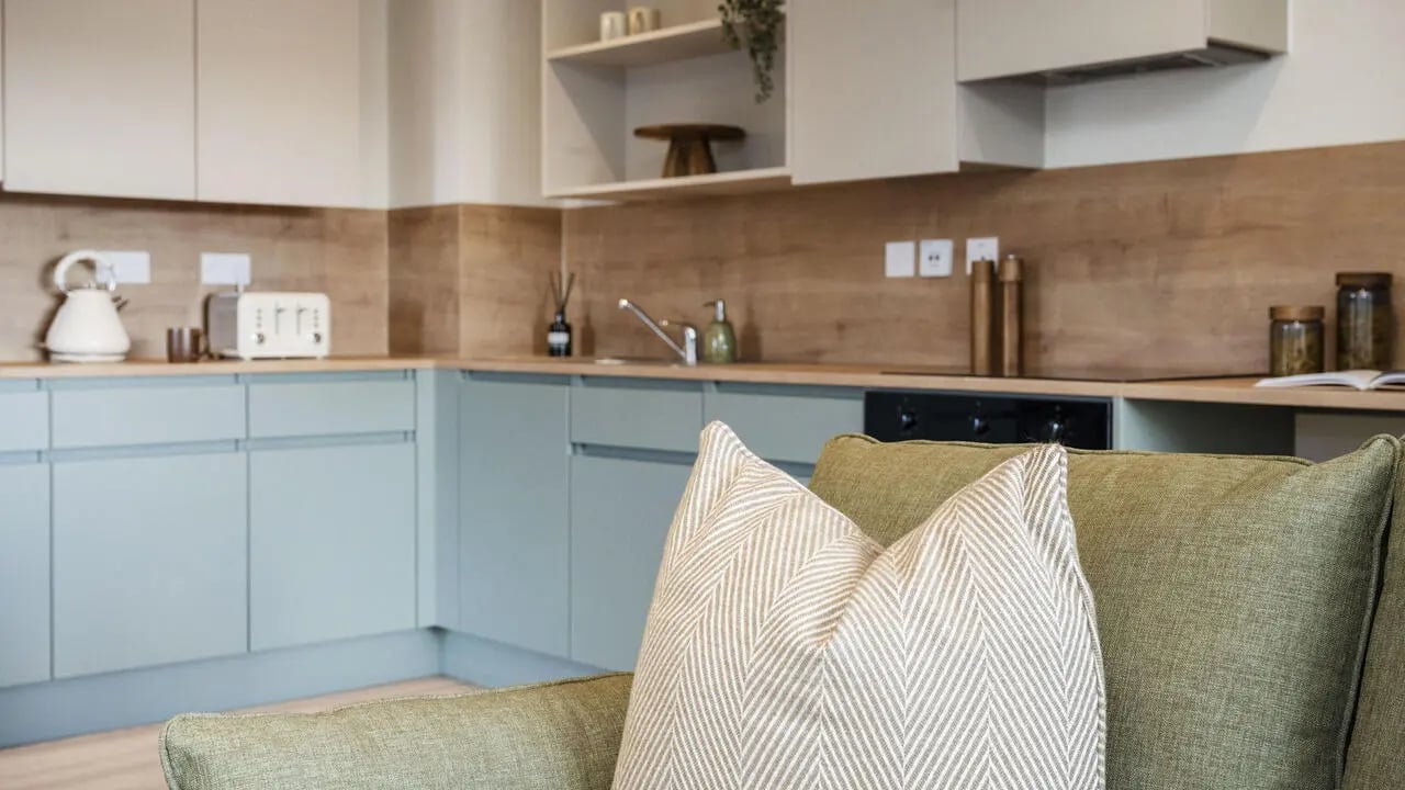 Kitchen with toaster kettle and sofa Living room at City Wharf in Glasgow Student Accommodation