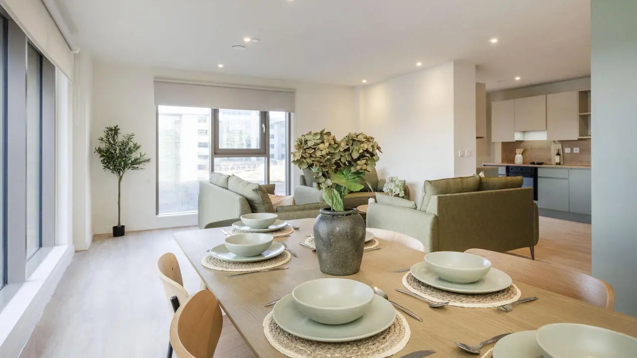 Dining table with place settings and plant living area kitchen at City Wharf in Glasgow Student Accommodation
