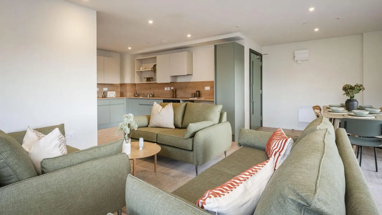 Sofas coffee table and kitchen living room at City Wharf in Glasgow Student Accommodation