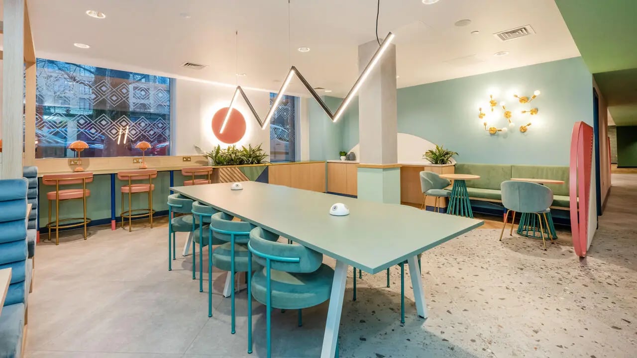 Long table chairs green banquettes lounge area at Wick Park in London Student Accommodation