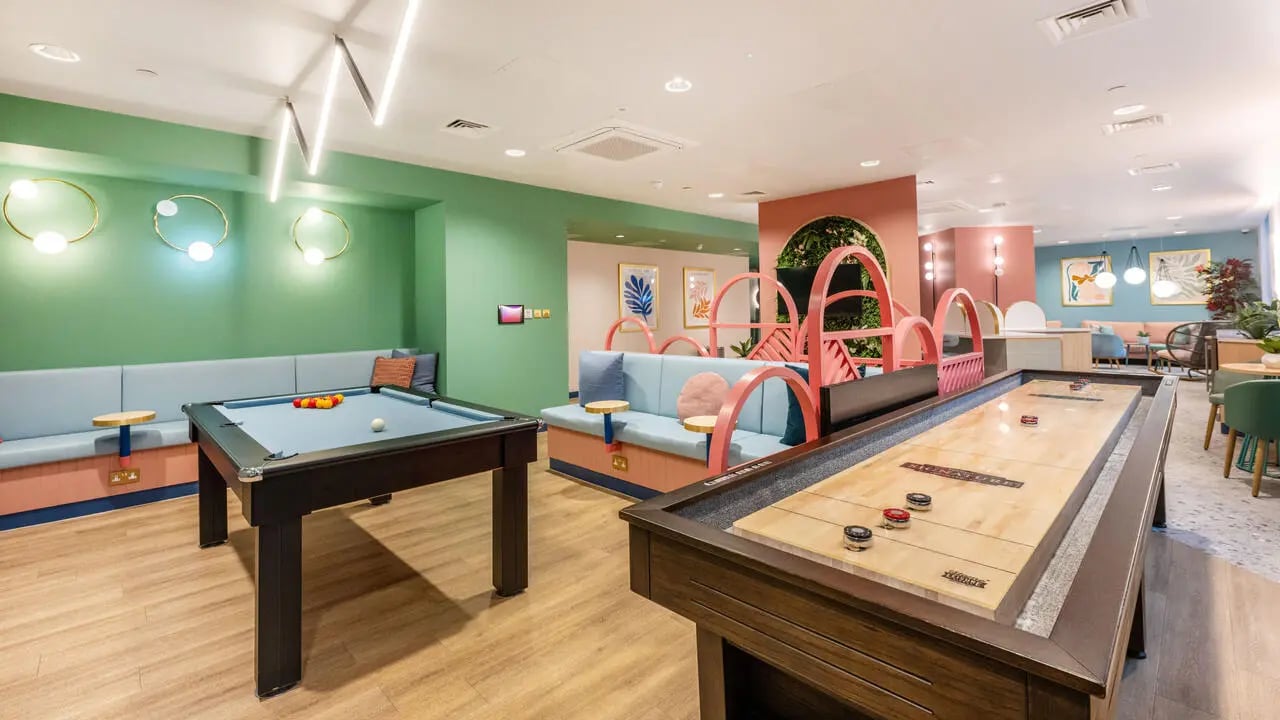 Pool table shuffleboard and lounge seating playing area at Wick Park in London Student Accommodation
