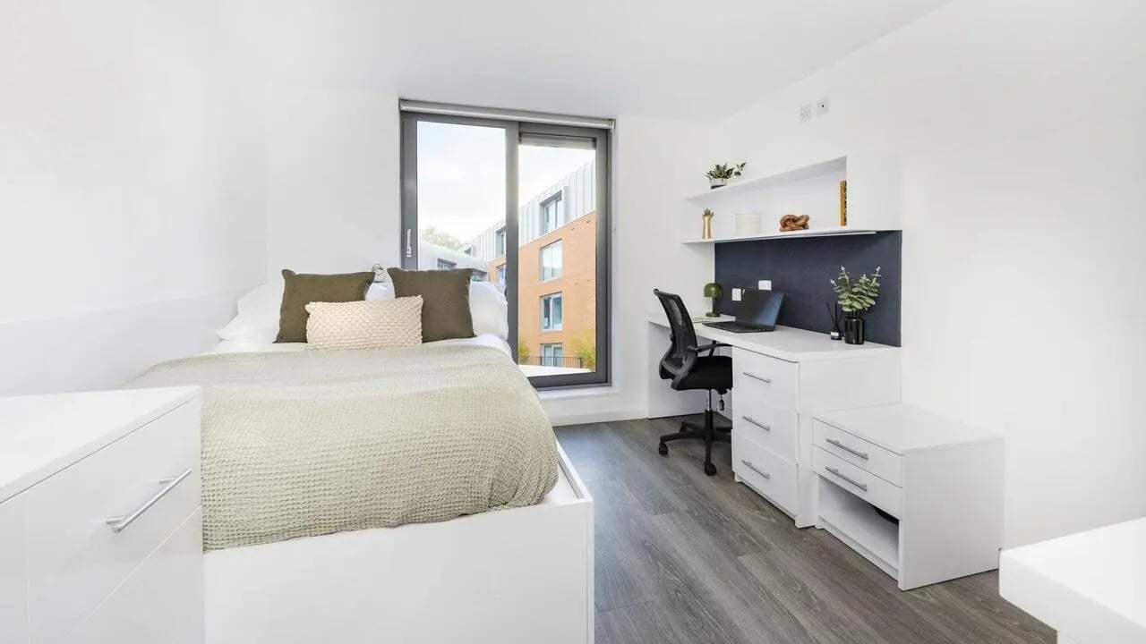 Bed desk chair and laptop bedroom study area at The Cube Ealing in London Student Accommodation