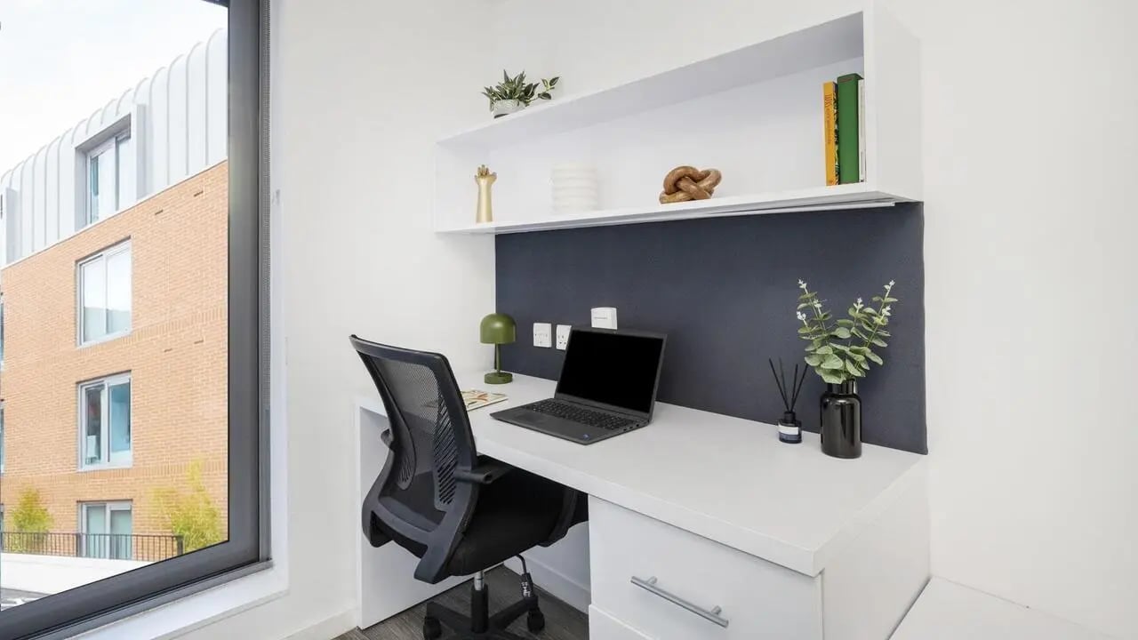Desk with laptop chair and shelf Study area at The Cube Ealing in London Student Accommodation