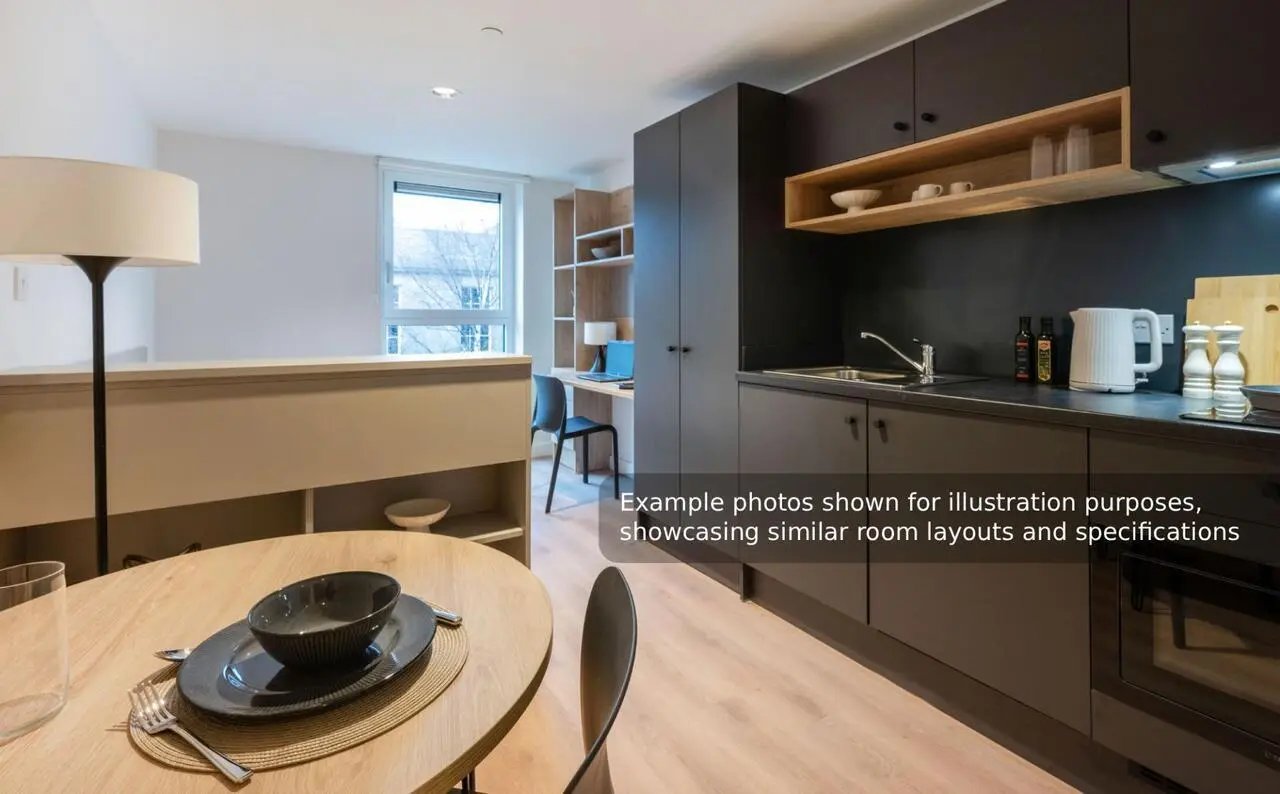Round table lamp window desk and kitchen area studio apartment at Straits Mile in Edinburgh Student Accommodation