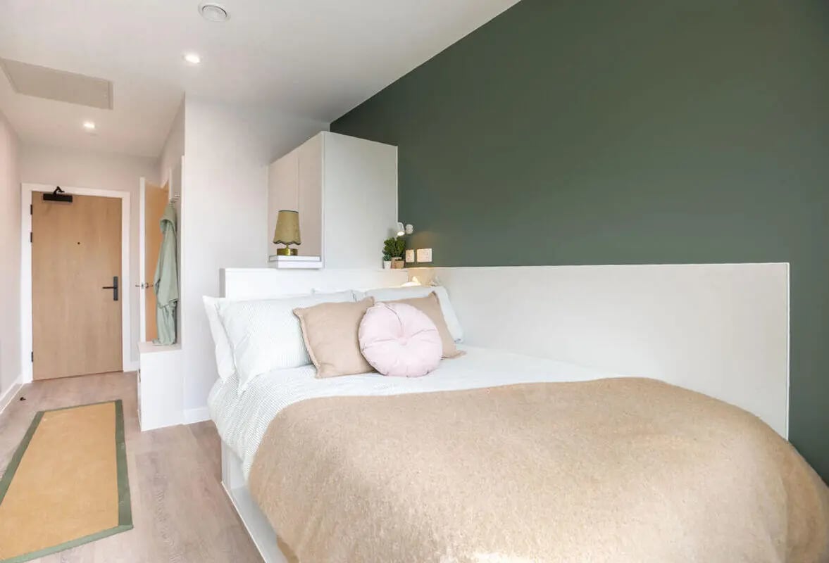Bed pillows blanket lamp and door bedroom at Yugo Haüs in Birmingham Student Accommodation