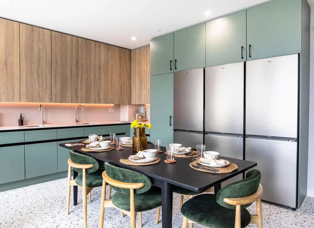 Dining table with chairs and appliances kitchen at Yugo Haüs in Birmingham Student Accommodation