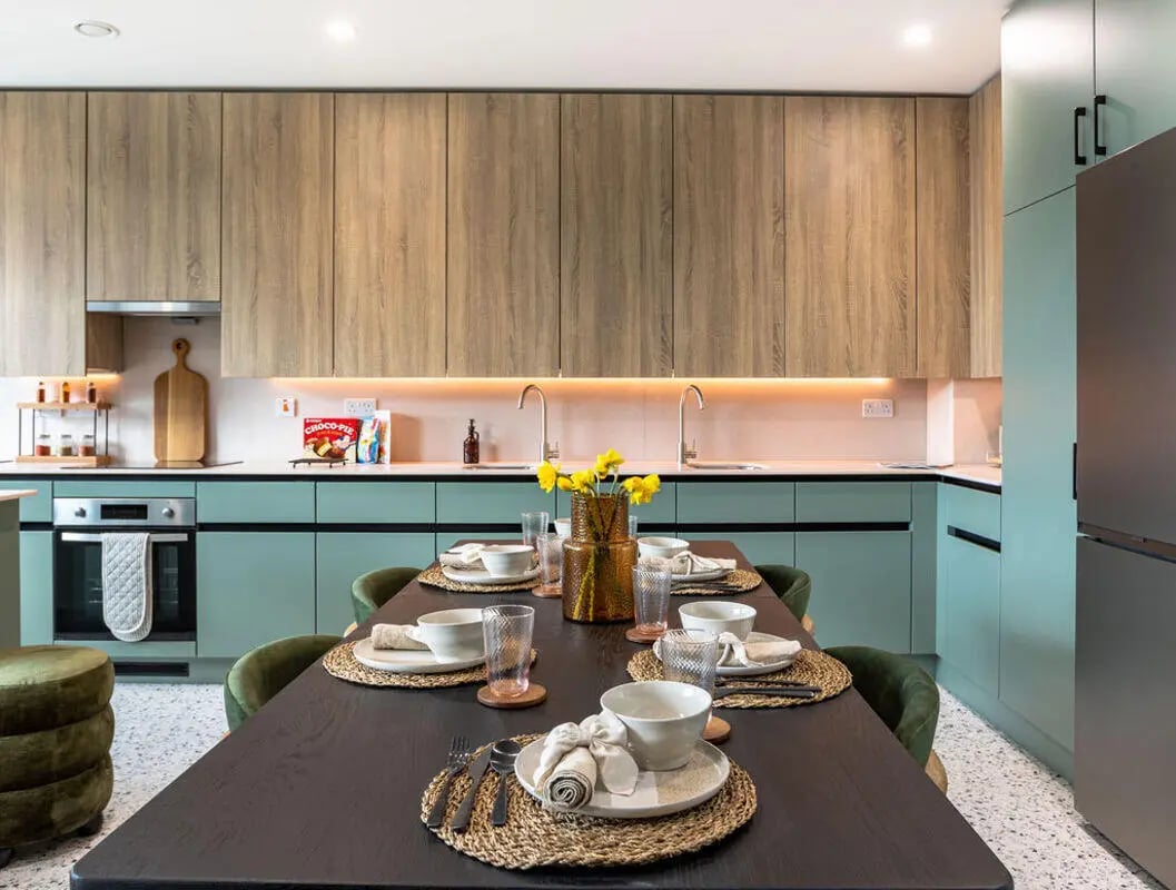 Dining table chairs vases and kitchen area kitchen at Yugo Haüs in Birmingham Student Accommodation