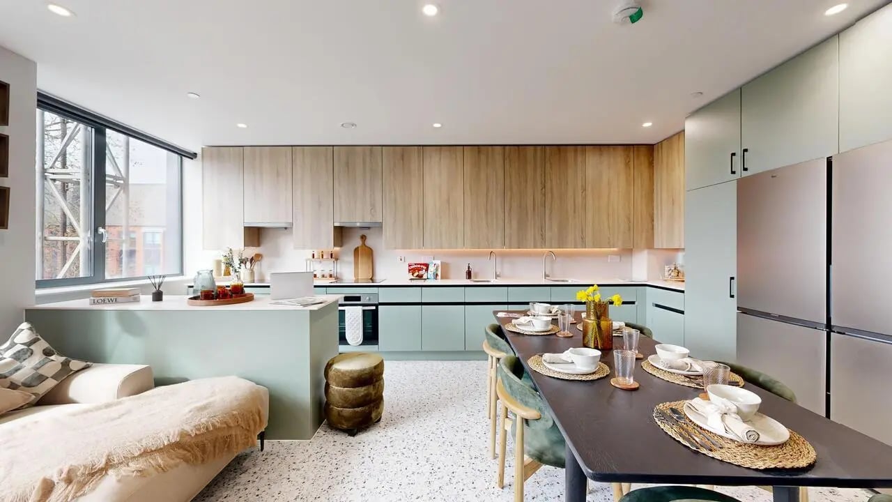 Sofa island dining table kitchen appliances kitchen dining area at Yugo Haüs in Birmingham Student Accommodation