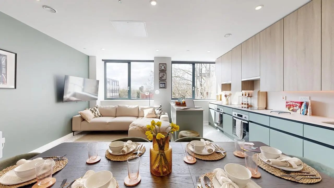 Lounge dining kitchen area with sofa and table. at Yugo Haüs in Birmingham Student Accommodation