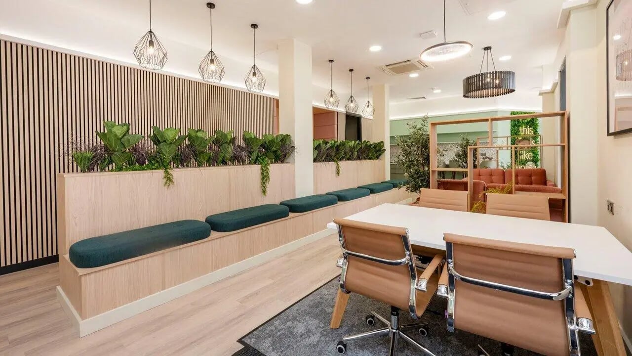 Wood slatted wall benches plants lounge and table area lounge at Fontenoy Apartments in Liverpool Student Accommodation