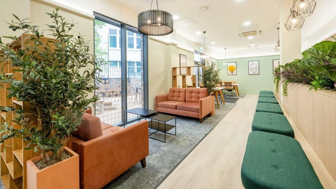 Orange sofas plant and seating lounge living room at Fontenoy Apartments in Liverpool Student Accommodation