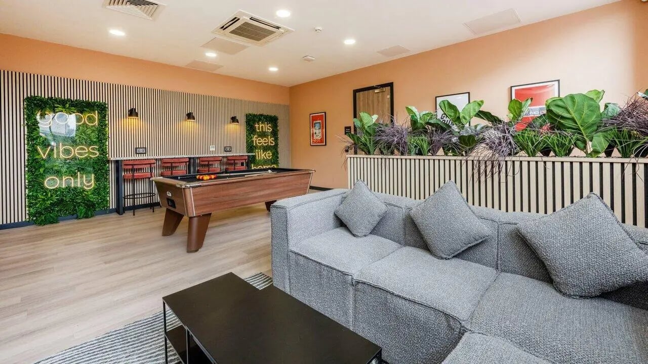 Pool table grey sofa neon signs living room at Fontenoy Apartments in Liverpool Student Accommodation