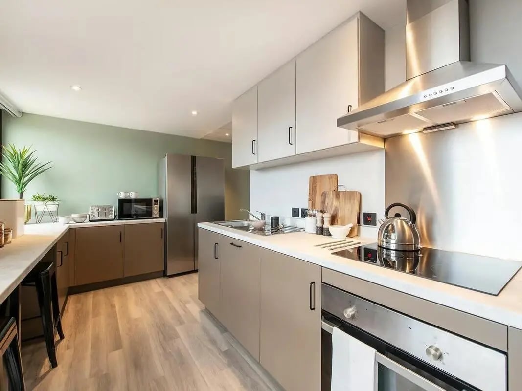 Modern kitchen with appliances countertops cabinets and dining stools Kitchen at Zenith in Cardiff Student Accommodation