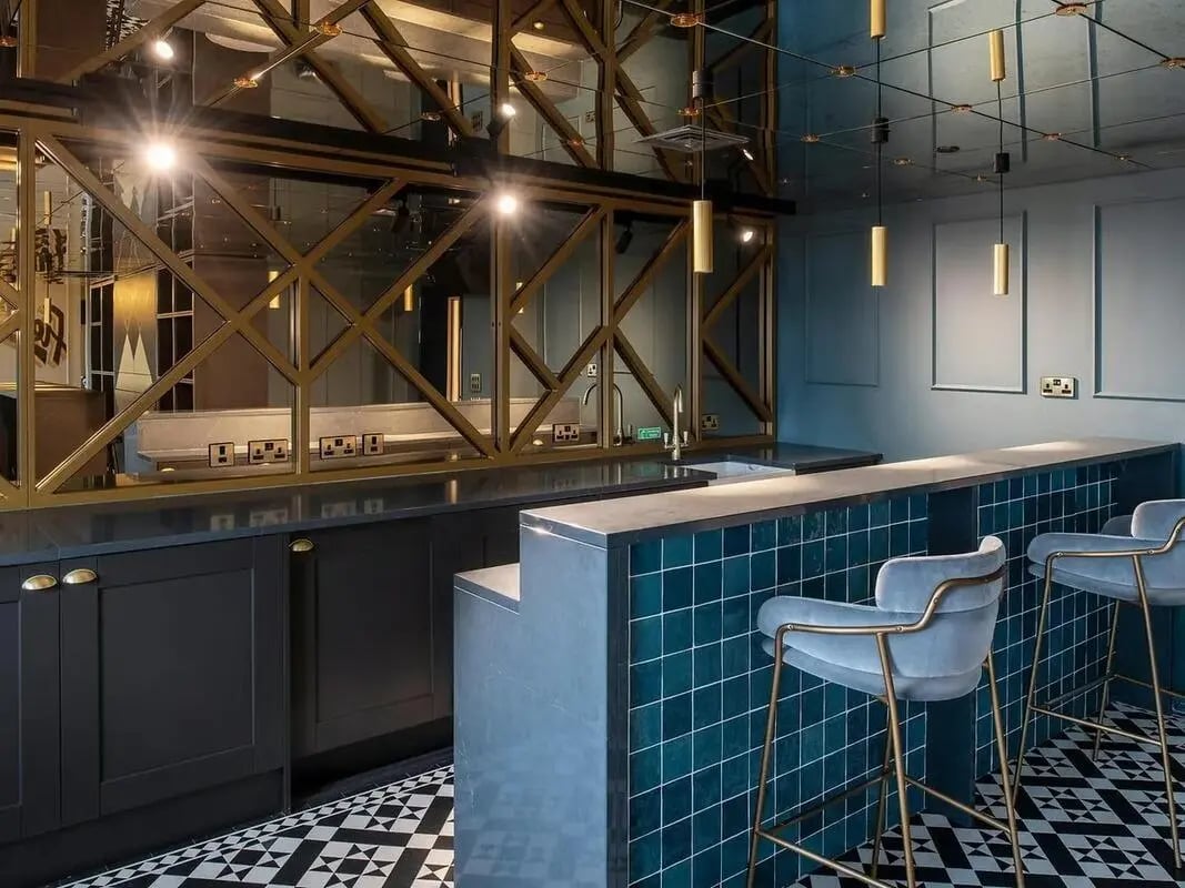 Bar area with stools and kitchen counter kitchen at Zenith in Cardiff Student Accommodation