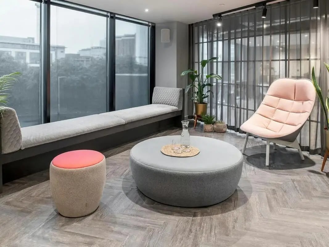 Round ottoman bench seat pink chair living room at Zenith in Cardiff Student Accommodation