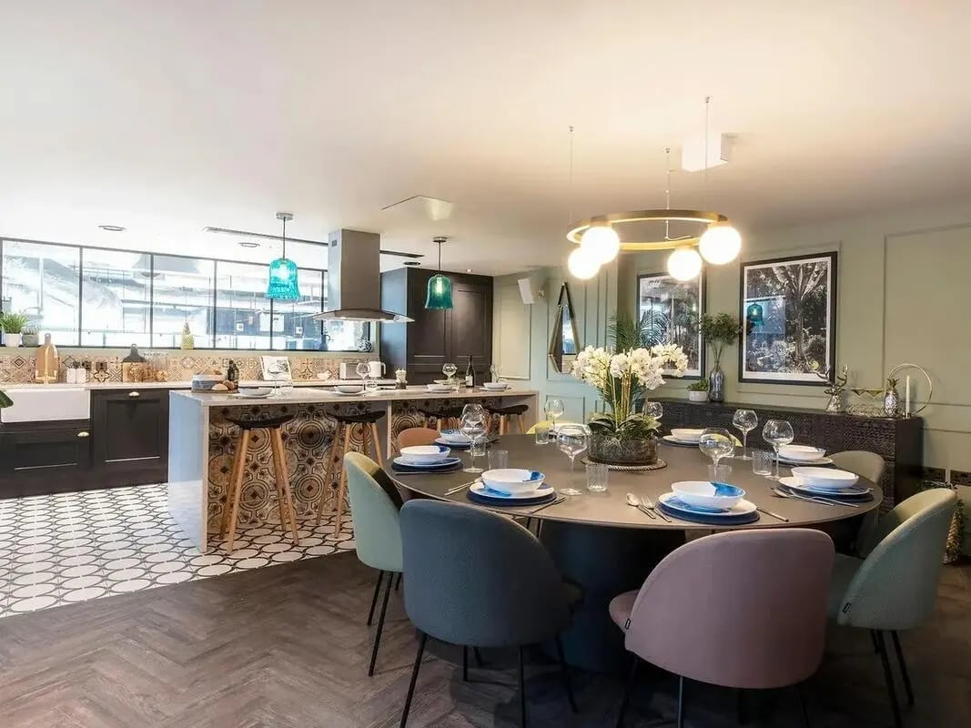 Dining table with chairs and kitchen island kitchen at Zenith in Cardiff Student Accommodation