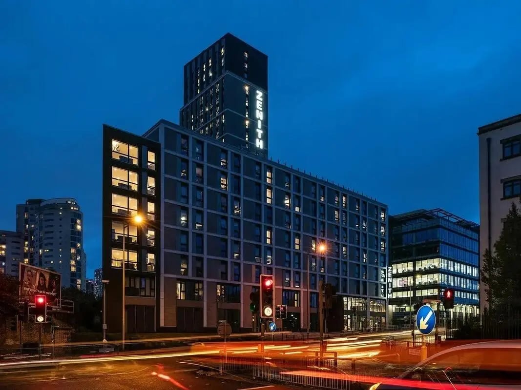 Zenith building with lit windows at dusk exterior at Zenith in Cardiff Student Accommodation