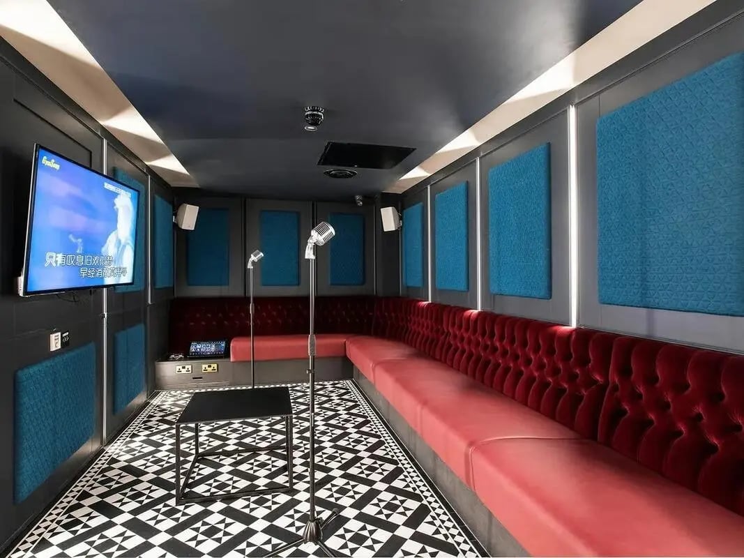 Karaoke room with red banquette and microphones playing area at Zenith in Cardiff Student Accommodation