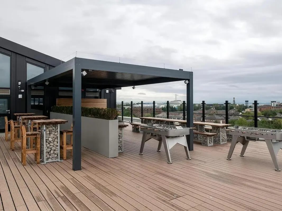Foosball tables and seating on rooftop patio outdoor area at Zenith in Cardiff Student Accommodation