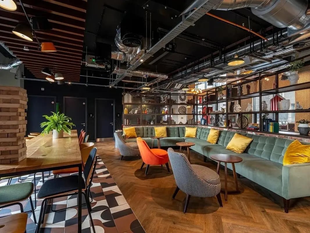 Lounge with sectional sofa tables chairs living area at Zenith in Cardiff Student Accommodation