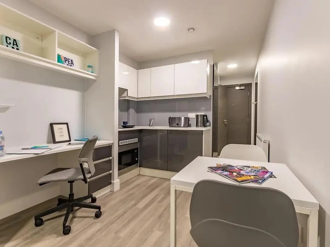 Desk chair kitchen counter table and chairs studio apartment at ViBe Student Living in Kingston Upon Thames Student Accommodation
