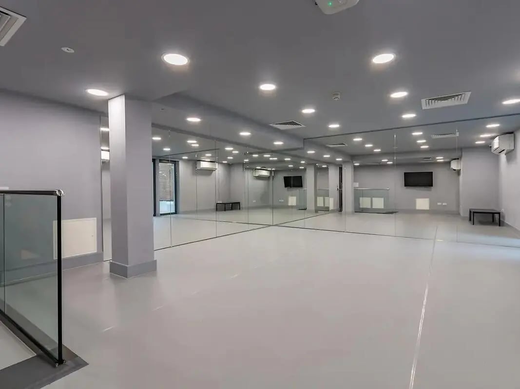Mirrored walls bright lights and benches playing area at ViBe Student Living in Kingston Upon Thames Student Accommodation