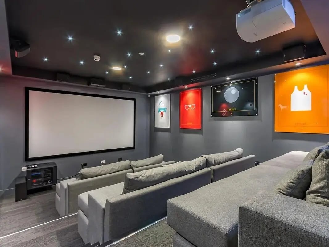 Tiered grey sofas facing large cinema screen Entertainment room at ViBe Student Living in Kingston Upon Thames Student Accommodation