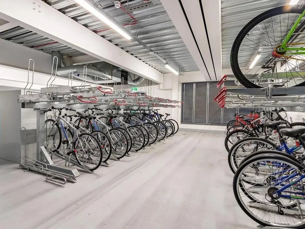 Multi-level bike racks with numerous bicycles parking facility at ViBe Student Living in Kingston Upon Thames Student Accommodation