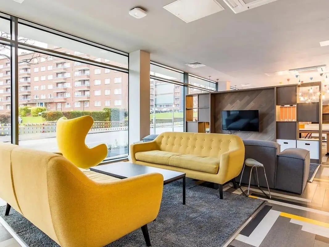 Yellow sofas grey sofa modern shelving living room at ViBe Student Living in Kingston Upon Thames Student Accommodation