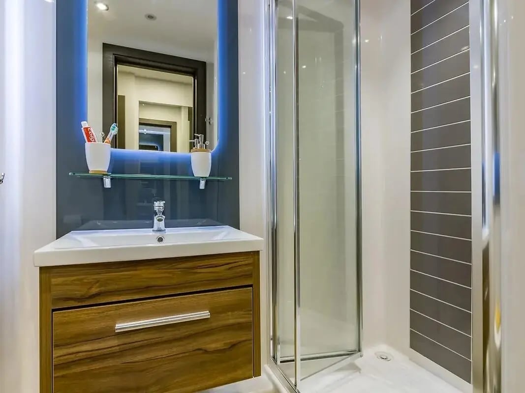 Sink cabinet mirror shower enclosure tiling bathroom at ViBe Student Living in Kingston Upon Thames Student Accommodation