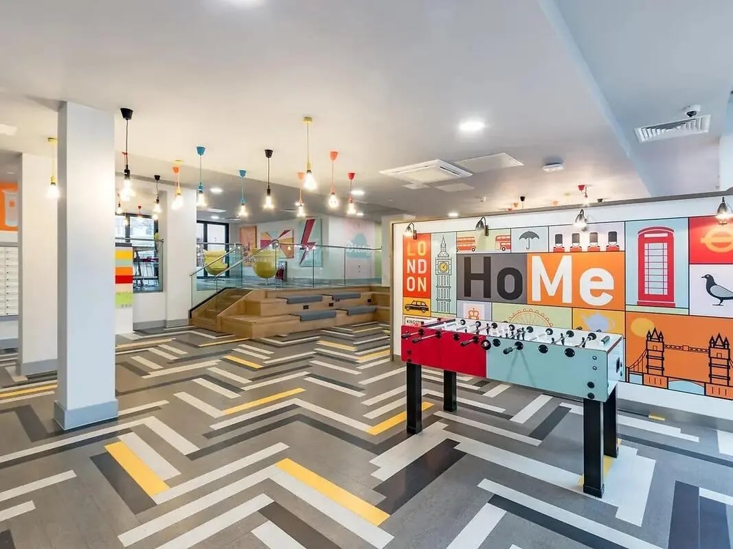 Foosball table tiered seating modern design common area at ViBe Student Living in Kingston Upon Thames Student Accommodation