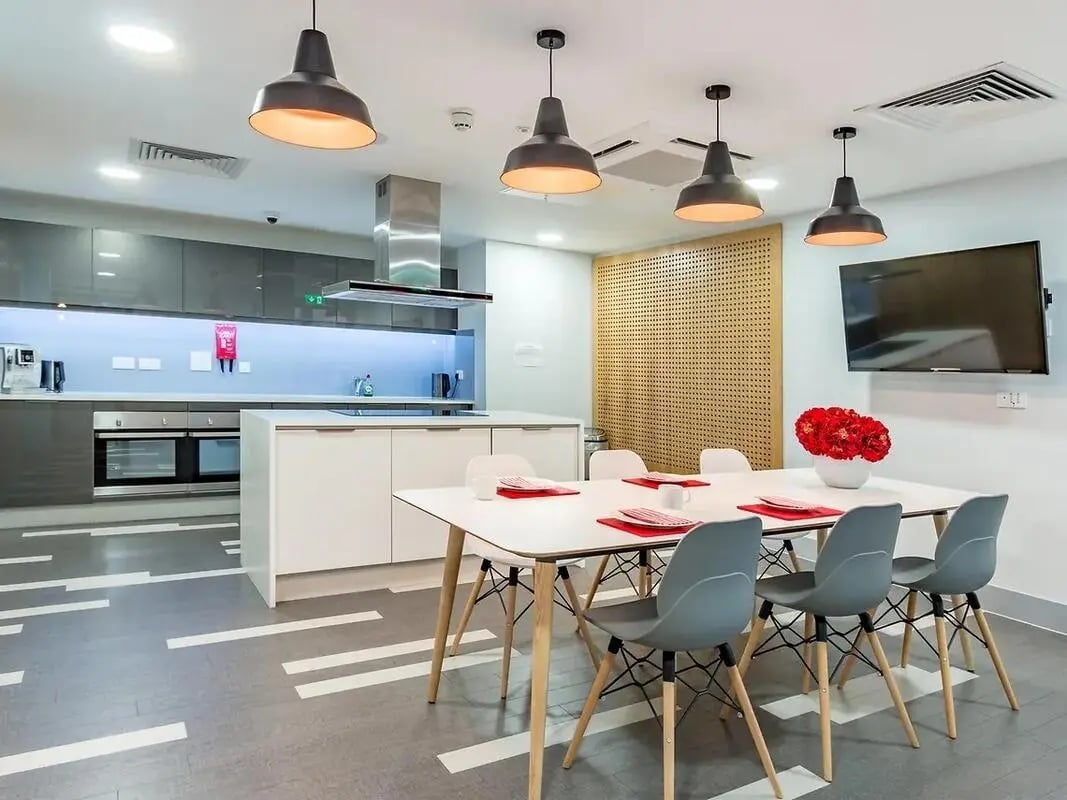 Modern communal kitchen with dining table and appliances kitchen at ViBe Student Living in Kingston Upon Thames Student Accommodation