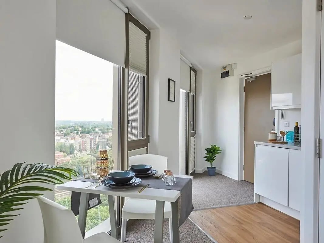 Dining table with place settings kitchen area living room at Felda House in Wembley Student Accommodation