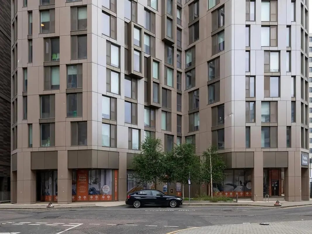 Modern building with apartments and parked car exterior at Felda House in Wembley Student Accommodation