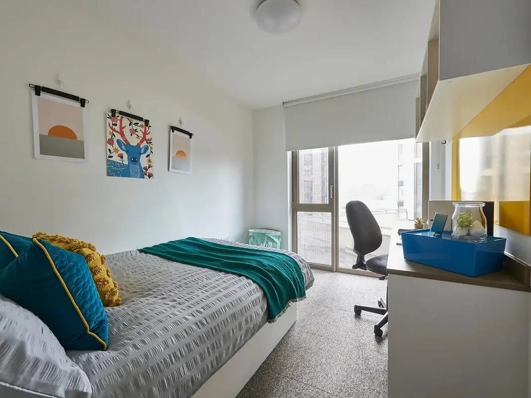 Bed desk chair artwork window Bedroom at Felda House in Wembley Student Accommodation