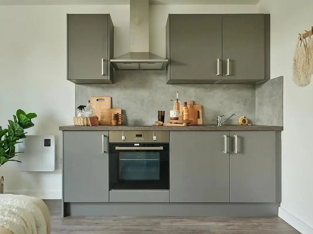 Grey cabinets oven sink cutting boards kitchen at The Reservoir in Plymouth Student Accommodation