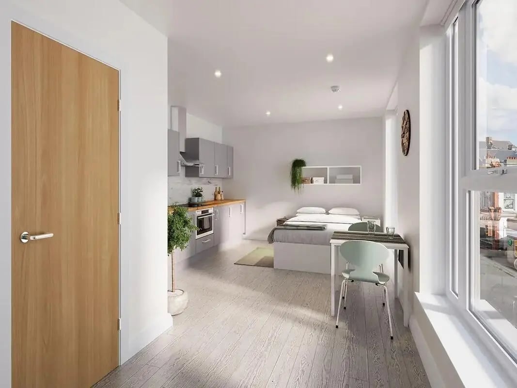 Bed kitchen table and chair studio apartment at The Reservoir in Plymouth Student Accommodation