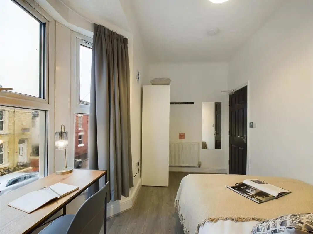 Desk lamp notebook and bed bedroom at 4 Bedroom House at 102, Leopold Road in Liverpool Student Accommodation