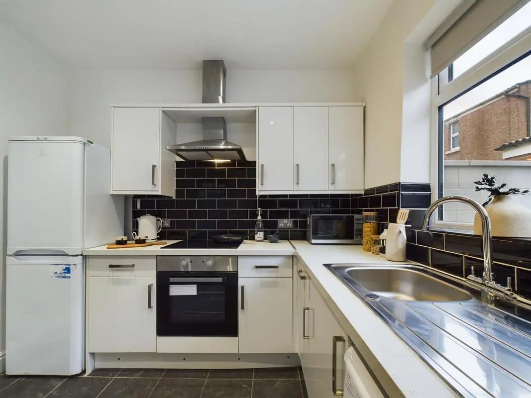 Fridge oven microwave sink cabinets black tile kitchen at 4 Bedroom House at 102, Leopold Road in Liverpool Student Accommodation
