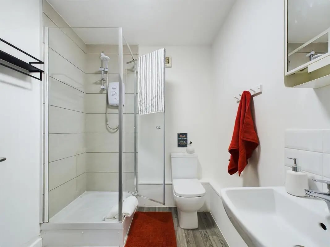 Shower toilet sink red towel bathroom at 6 Bedroom House at 2, Flat 2, Windsor House, Clint Road West in Liverpool Student Accommodation