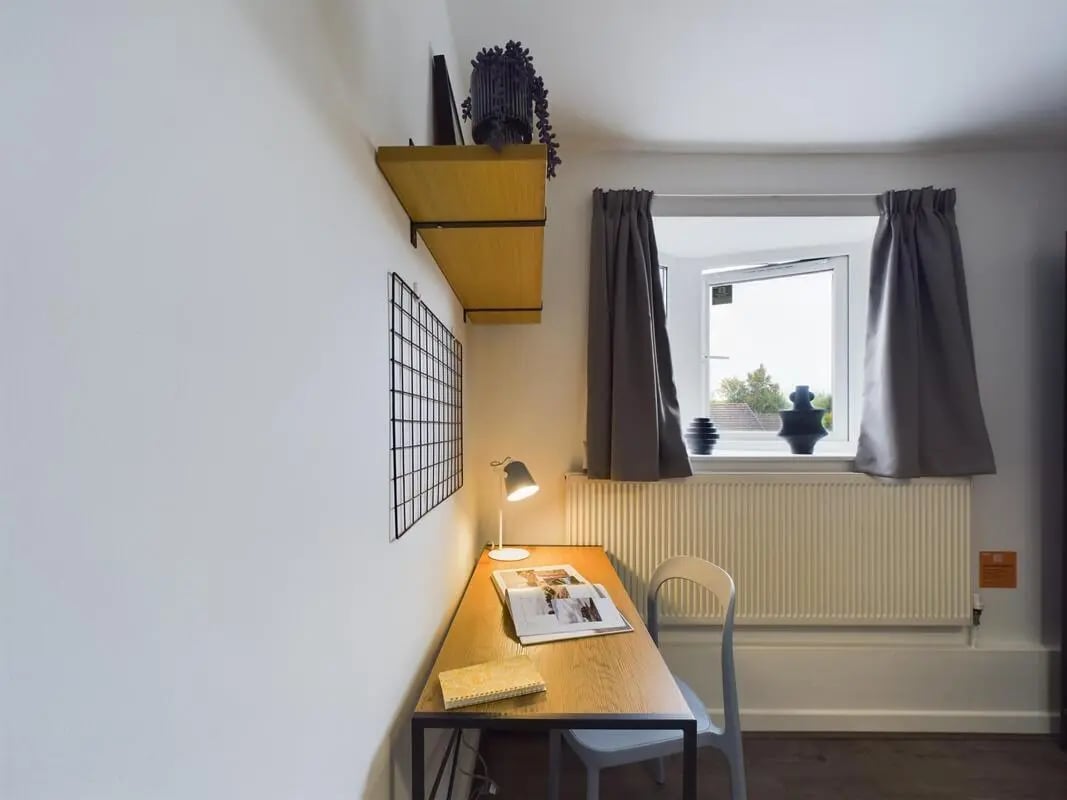 Desk lamp chair shelves window study area at 6 Bedroom House at 2, Flat 2, Windsor House, Clint Road West in Liverpool Student Accommodation