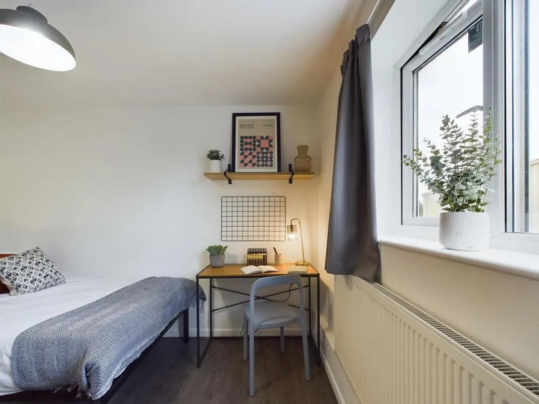 Bed desk lamp plants and framed art bedroom at 6 Bedroom House at 2, Flat 2, Windsor House, Clint Road West in Liverpool Student Accommodation