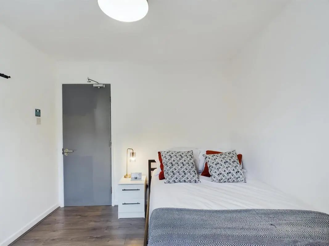 Bed nightstand lamp and door bedroom at 6 Bedroom House at 2, Flat 2, Windsor House, Clint Road West in Liverpool Student Accommodation