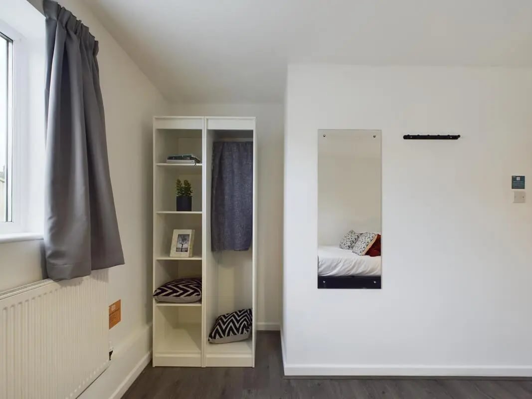 White shelf with pillows blanket and mirror bedroom at 6 Bedroom House at 2, Flat 2, Windsor House, Clint Road West in Liverpool Student Accommodation