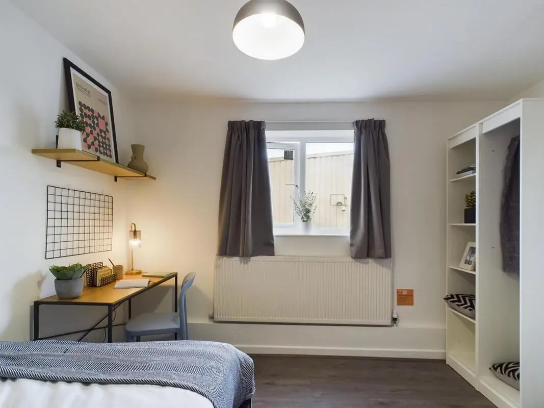Desk chair shelves and bed bedroom at 6 Bedroom House at 2, Flat 2, Windsor House, Clint Road West in Liverpool Student Accommodation
